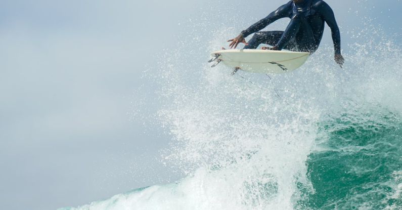 Dynamics - Man Jumping on a Surfboard, and Water Splash